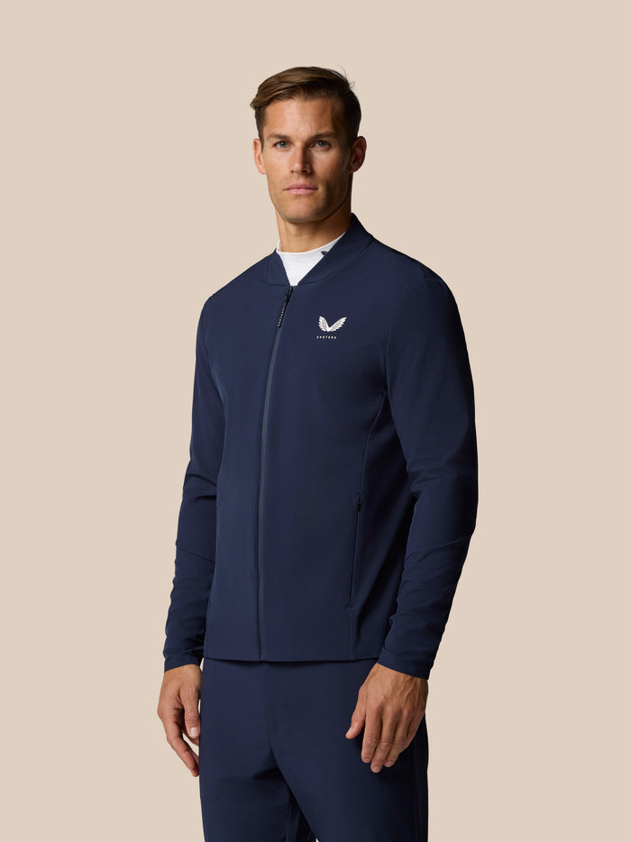 Man wearing midnight navy LVS jacket with front zip and Castore logo on chest.