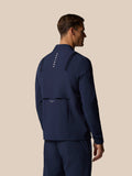 Back view of navy LVS jacket with accordion tape at the back and Castore branding on the upper back.