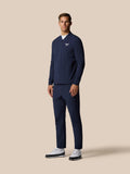 Male model wearing midnight navy Golf Pinnacle LVS Winter Jacket with full front zip and left chest Castore logo