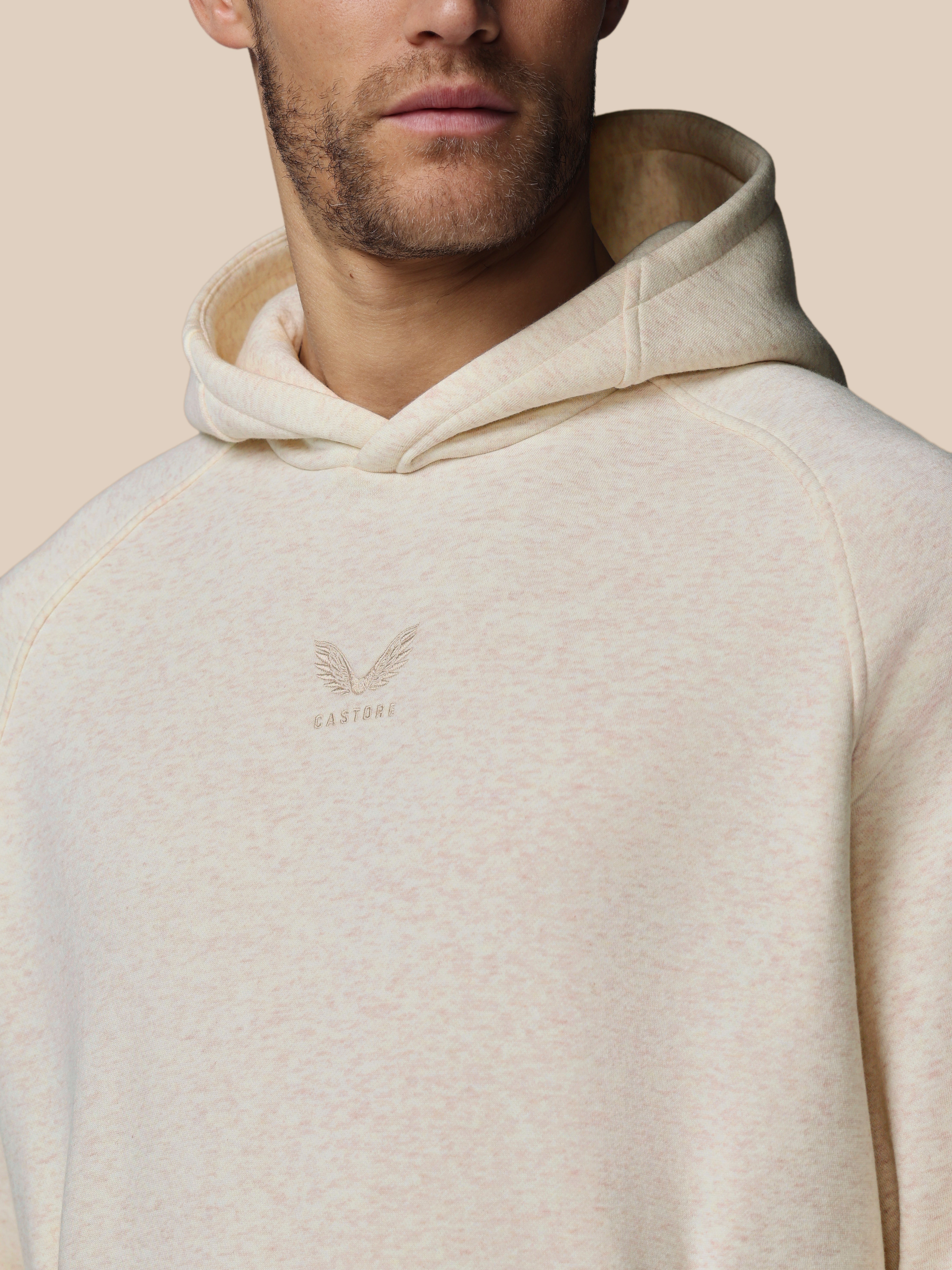 Beige hoodie with a brand logo on a beige background