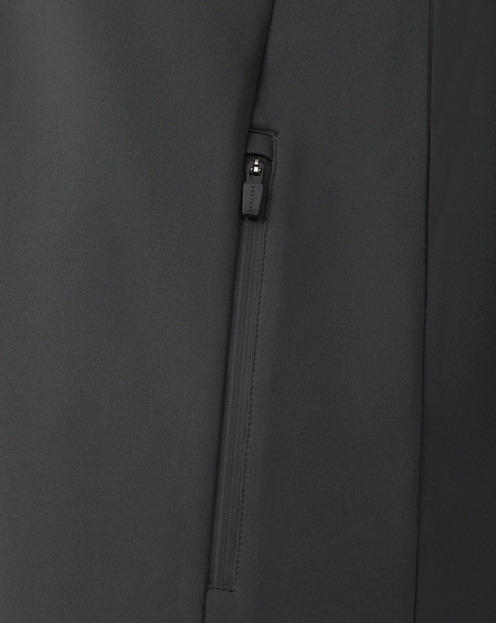 Close-up of a black zip pocket on performance fabric with a visible seam