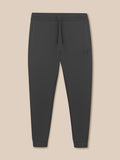 Dark gray jogger pants on a beige background
