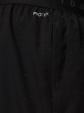 Close-up of a black jacket with 'PROTEK' branding on a dark background