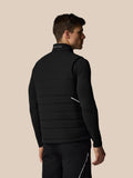 Man wearing a black puffer vest on a beige background