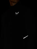Black hoodie with a logo on the chest and reflective strip on the sleeve against a dark background