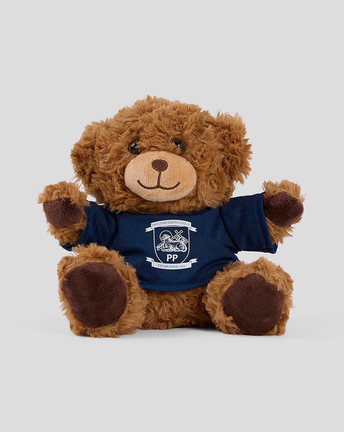 Brown plush teddy bear wearing a navy T shirt with a crest