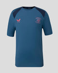 Blue junior training short sleeve tee with dark navy shoulder panels and crest on the chest