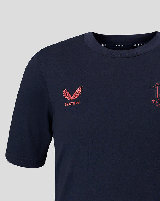 Close up of navy travel T shirt chest with coral crest embroidery