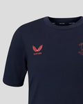 Close up of navy travel T shirt chest with coral crest embroidery