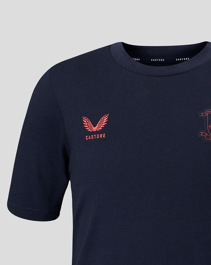 Close up of navy travel T shirt chest with coral crest embroidery