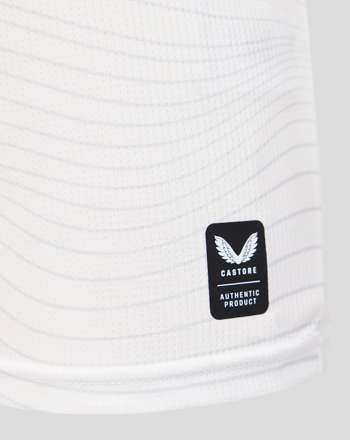 Castore authentic product patch on white jersey fabric near the hem