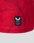 Close up of red fabric with Castore authentic product badge
