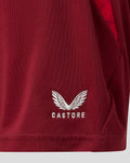 Close-up of burgundy PNE Junior third shorts fabric with white Castore wing logo near the hem.