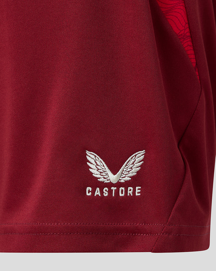 Close-up of burgundy PNE Junior third shorts fabric with white Castore wing logo near the hem.