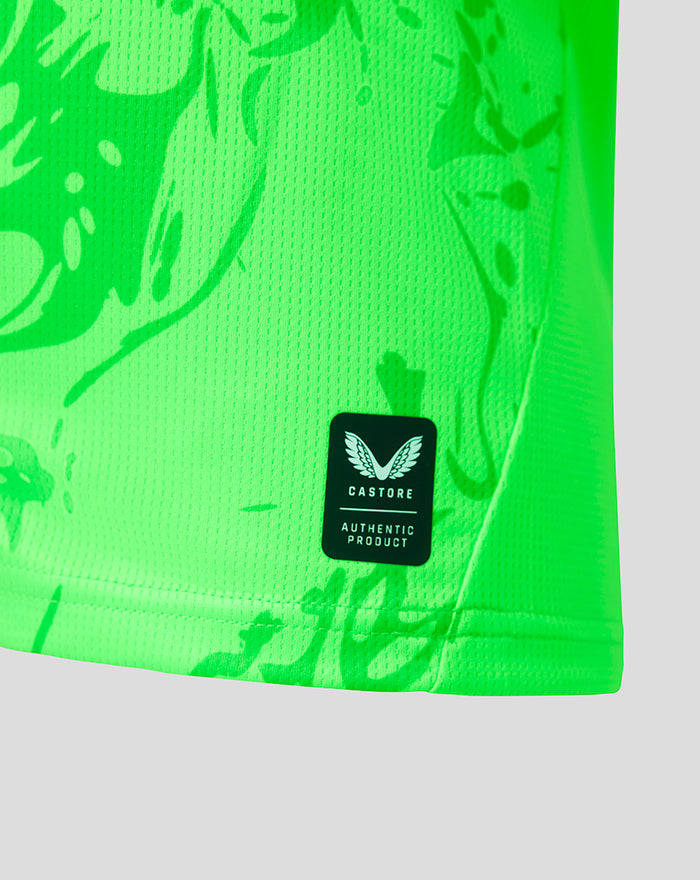 Detail of neon green jersey fabric with CASTORE Authentic Product patch near the hem