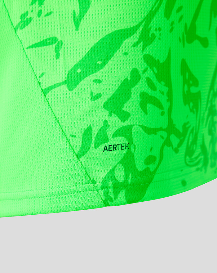 Close up of neon green goalkeeper shirt fabric with AERTEK badge and abstract print