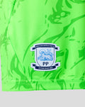 Close up of neon green fabric showing the Preston North End FC crest on the shorts.