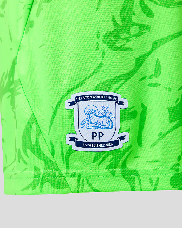 Close up of neon green fabric showing the Preston North End FC crest on the shorts.