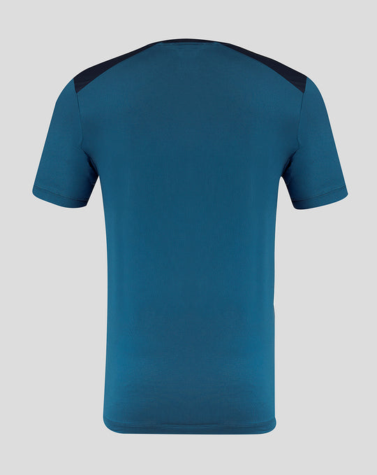 Back view of teal blue PNE training short sleeve tee with navy shoulder panels.