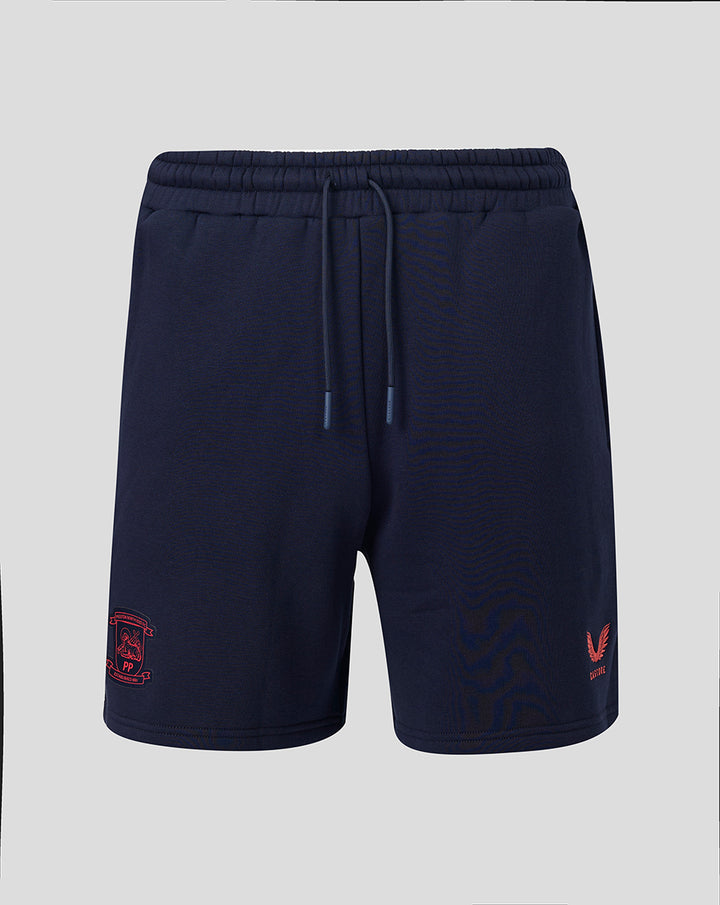 Navy Travel Adapt fleece shorts with coral crest on the left leg and a drawstring waist.