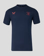 Navy travel T-shirt with coral badge and Castore logo on the chest