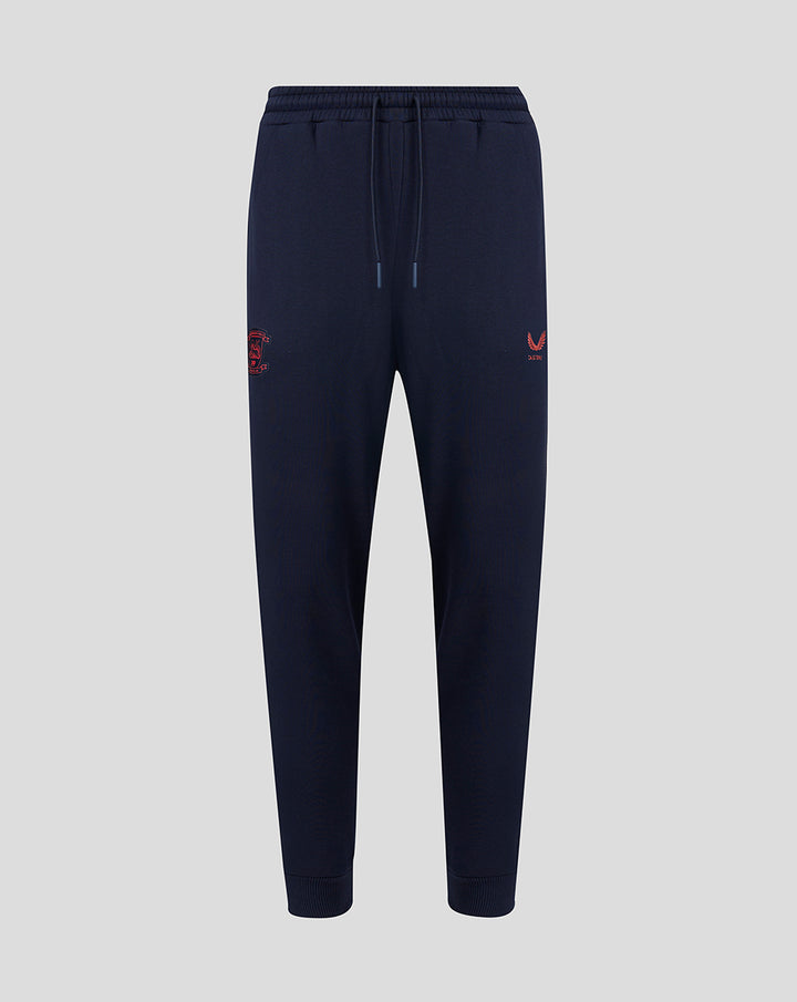 Navy Travel Adapt fleece joggers with drawstring waist, secure pockets and coral branding on the leg.