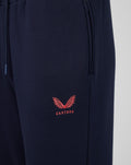 Navy travel fleece jogger close up with coral Castore logo near the pocket.