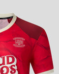 Close up of the red PNE jersey front highlighting the chest crest and the textured fabric pattern.