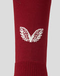 Close-up of white wing logo on burgundy PNE third sock knit.