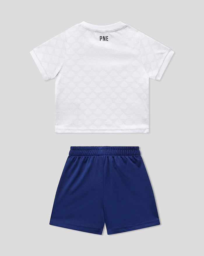 Back view of a white baby kit top with PNE branding at the neck and blue shorts.