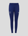 Front view of women's training knit pant in blue with crest and wing logos on the thighs.