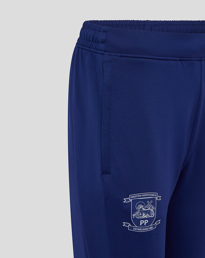 Blue women's training knit pant with elastic waistband and side pocket; white club crest near the hem.