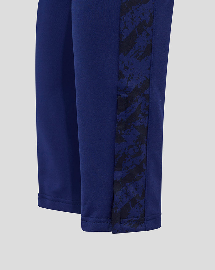 Blue training pant with a contrasting printed side panel and stitched hem detail.