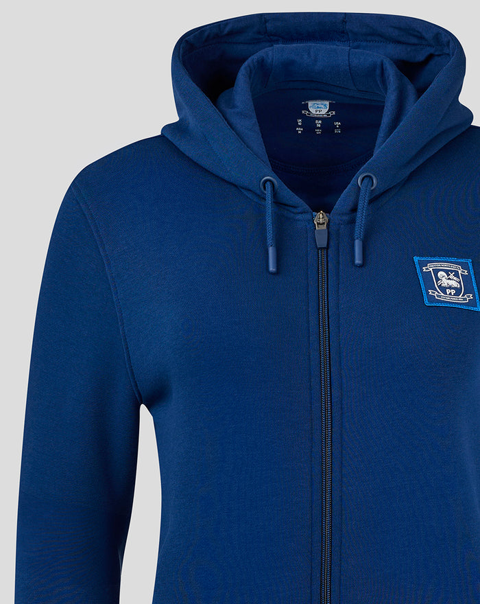 Close up of navy women's full zip hoodie showing front zipper and chest emblem patch.