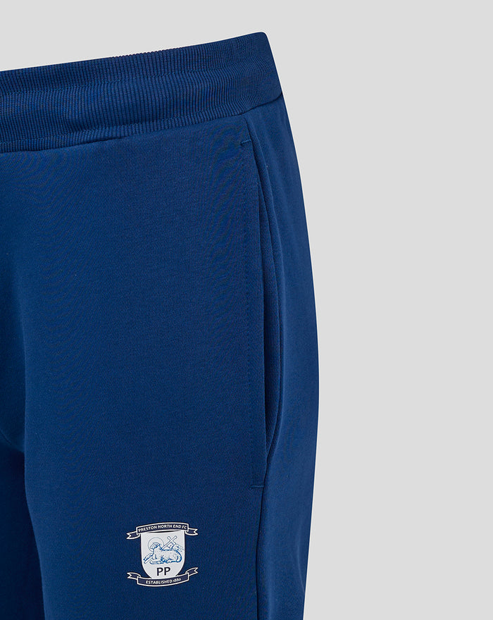 Close-up of navy women's core joggers waistband with drawstring and crest emblem on the leg
