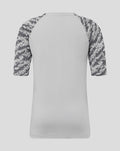 Back view of grey junior training tee with camo patterned sleeves.