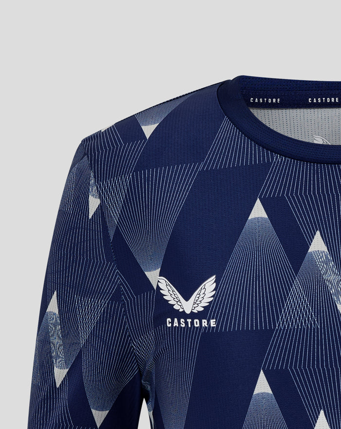 Close-up of navy Junior 25/26 Matchday shirt with geometric pattern and left chest crest.