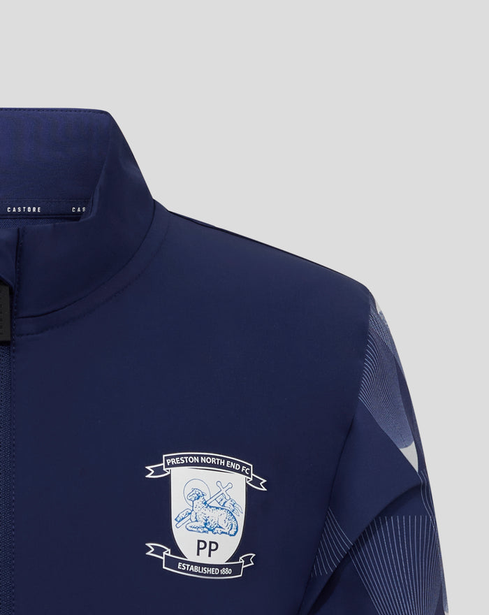 Back view of navy junior matchday jacket with geometric striped sleeves and ribbed cuffs.