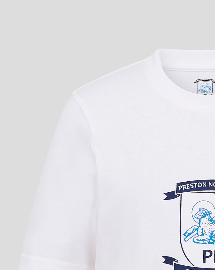 Close up of white fabric displaying part of the crest emblem on the chest.