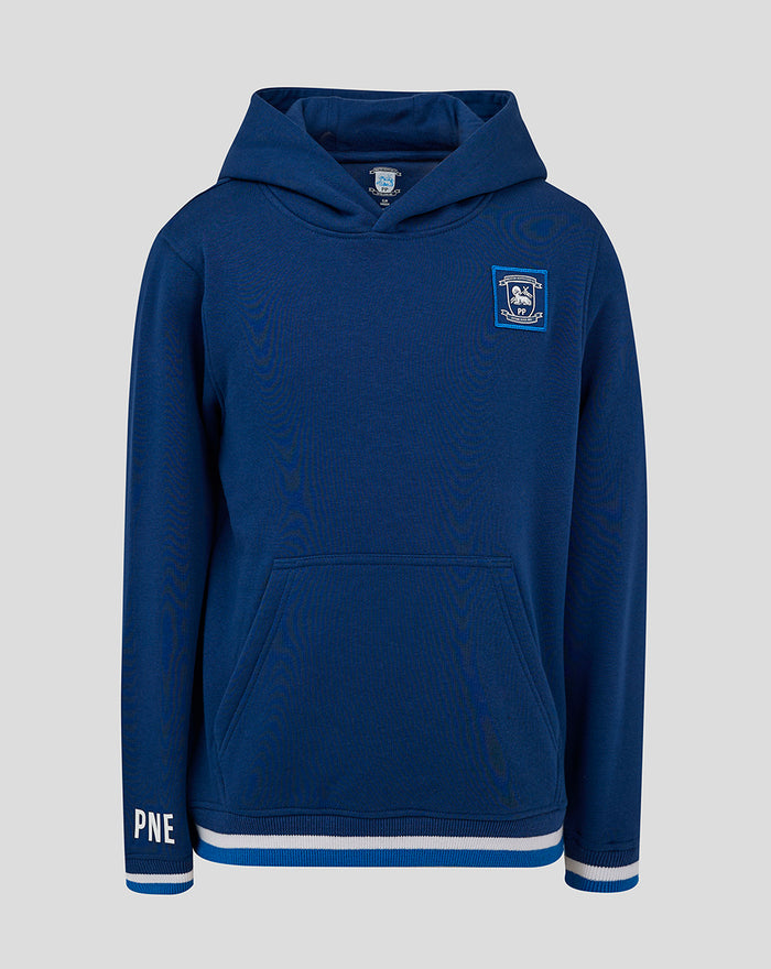 Front view of navy junior classic hoodie with crest badge on chest kangaroo pocket and striped hem
