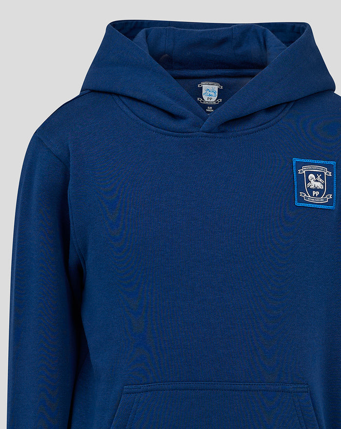 Close-up of navy junior classic hoodie showing hood and woven badge at left chest