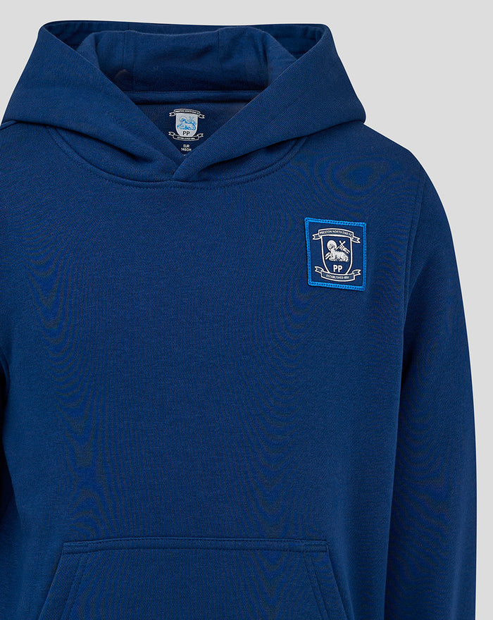 Close up of navy hoodie showing crest badge on left chest and a large hood