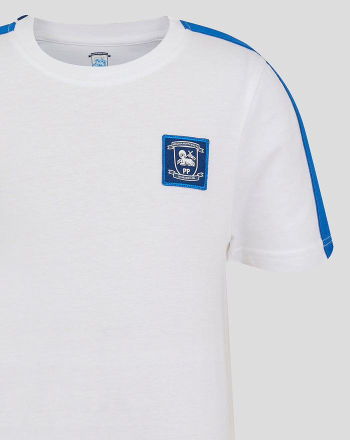 Front view of white junior classic cotton T shirt with blue shoulder stripes and a chest crest patch.