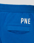 Close up of blue junior classic short waistband with ribbed knit and partial white lettering