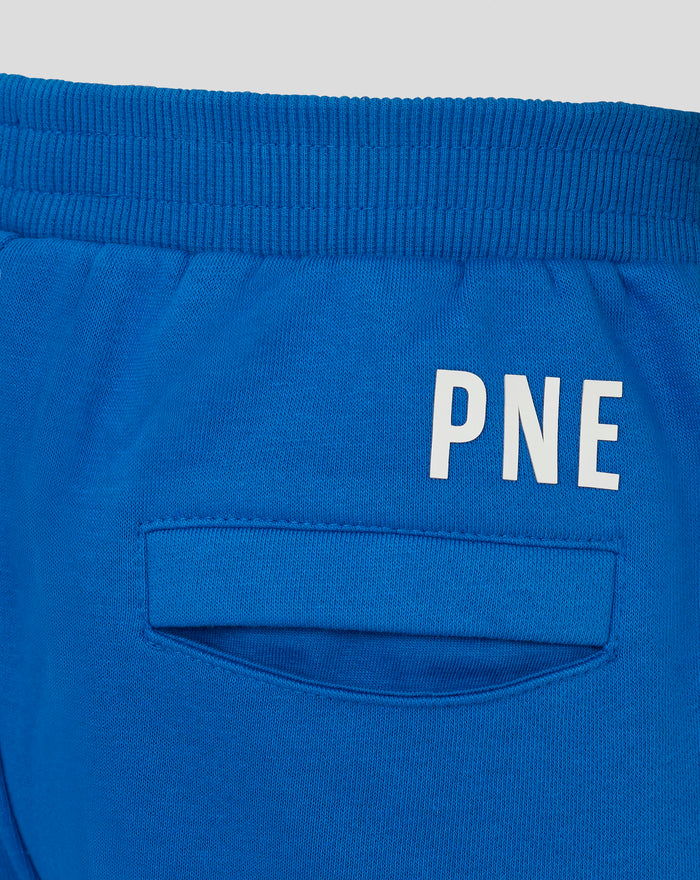 Close up of blue junior classic short waistband with ribbed knit and partial white lettering