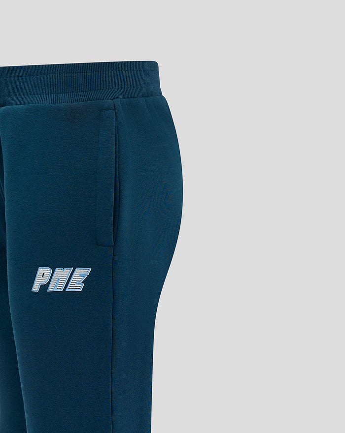 Close-up of dark blue joggers with a small logo on the left thigh