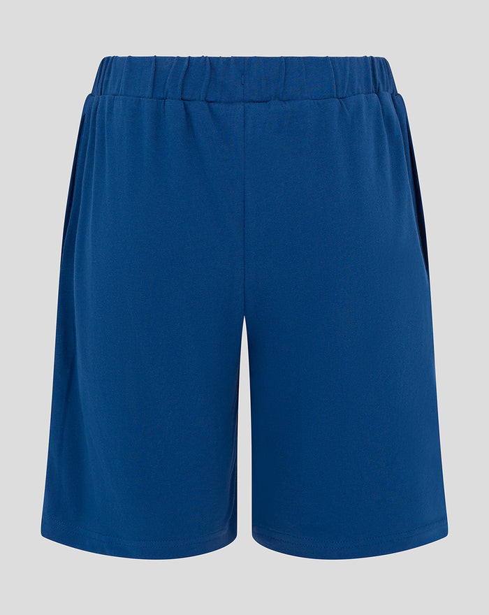 Back view of blue junior shorts with an elastic waistband.