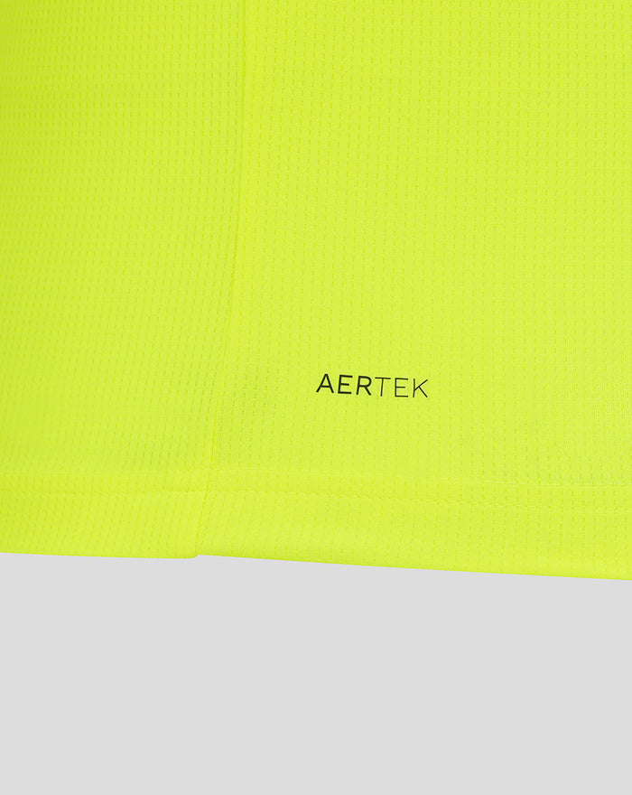 Close-up of neon lime fabric with AERTEK branding near the bottom hem.