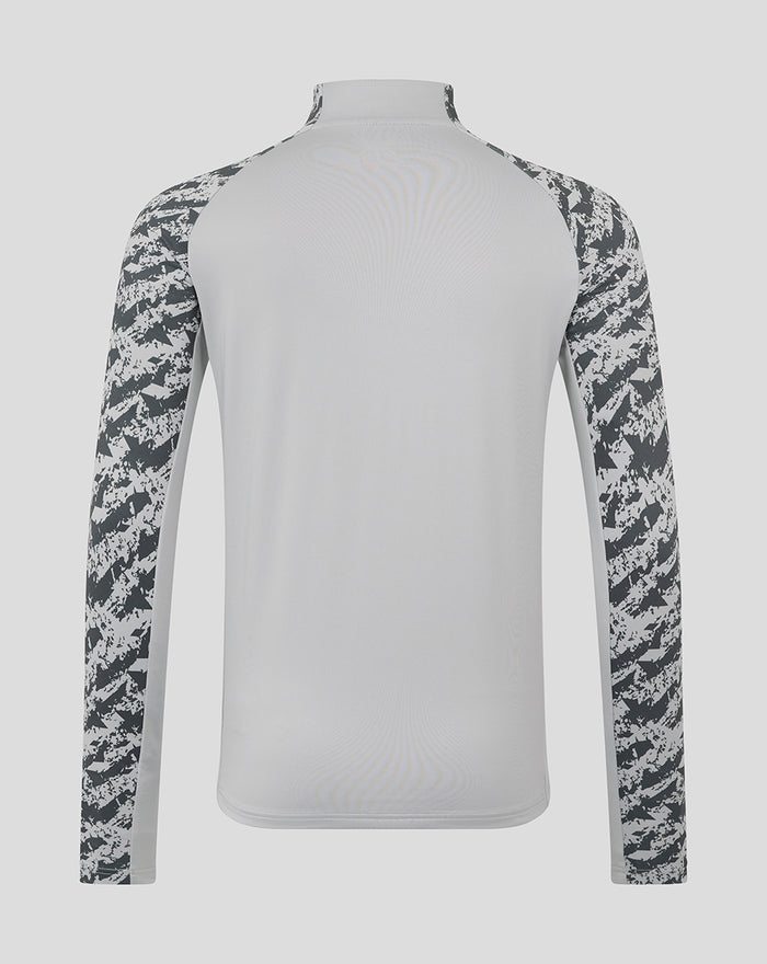 Back view of light grey training midlayer with solid back and camo patterned sleeves.