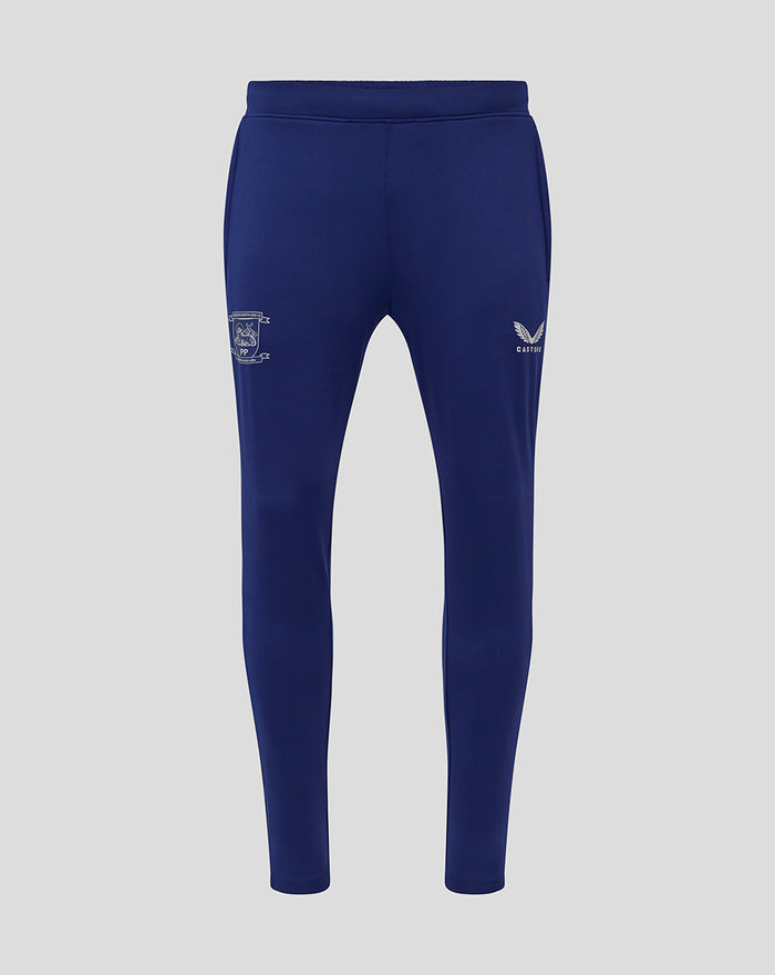 Front view of navy training knit pant with two side pockets, crest on left thigh and Castore logo on right